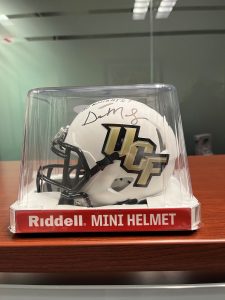 Photo of a mini-UCF football helmet signed by Gus Malzahn.